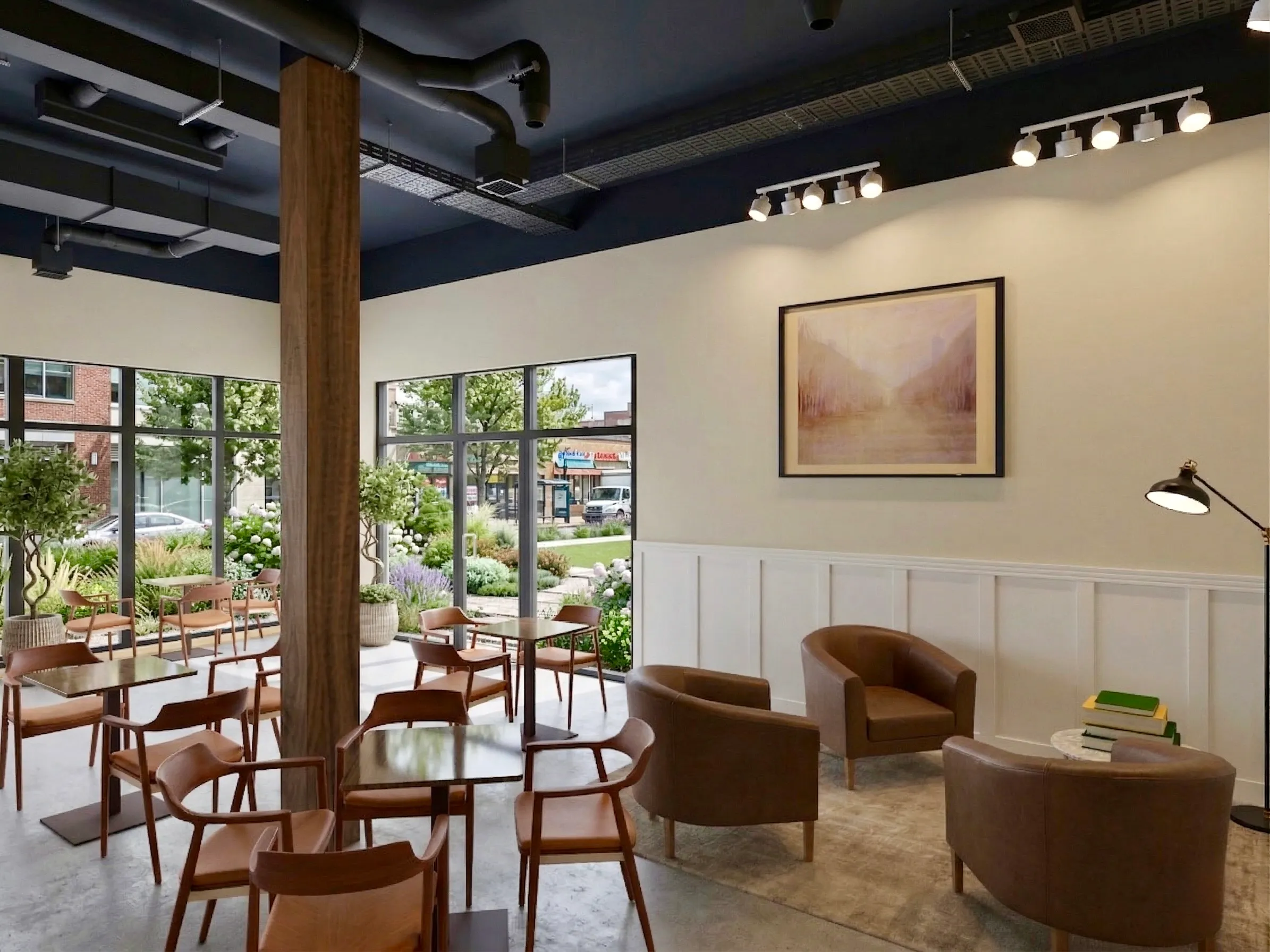 A bright corner of the cafe with floor-to-ceiling windows looking onto a garden.
